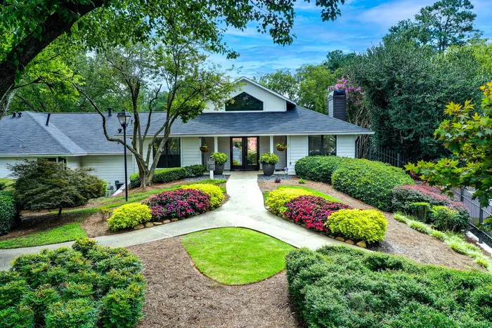 Clubhouse entrance with lush landscaping