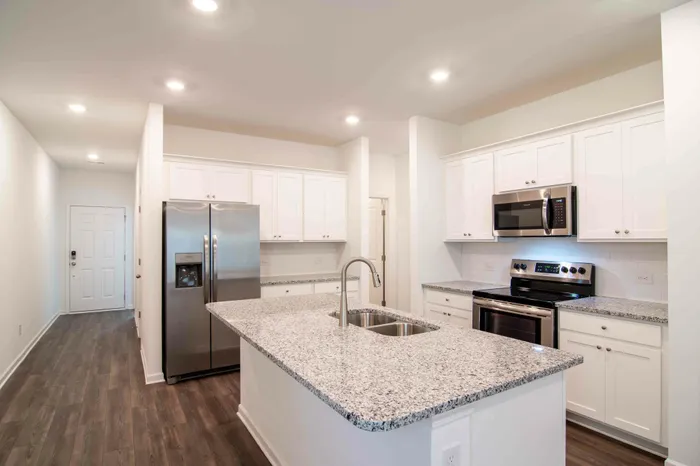 kitchen island with white cabinets and stainless steel appliances