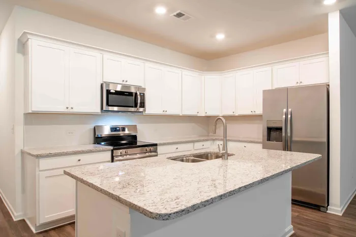 kitchen island with white cabinets and stainless steel appliaces