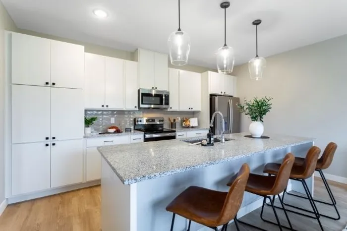 Kitchen with island and brown chairs