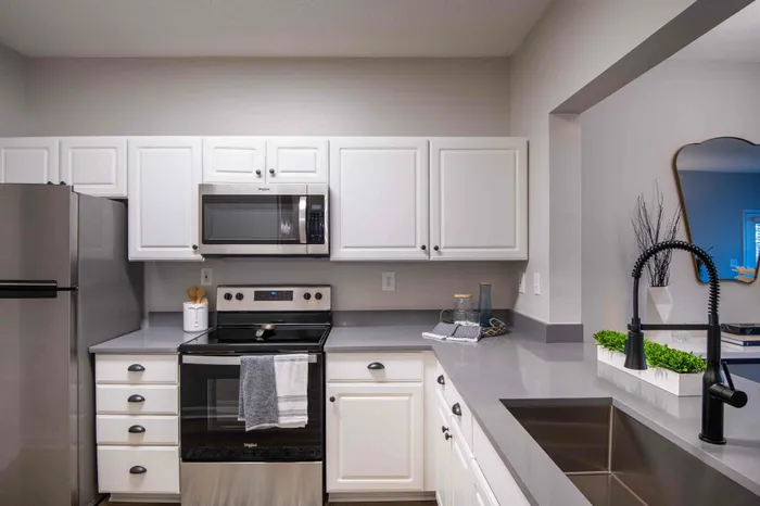 Kitchen with white shaker cabinets and stainless steel appliances