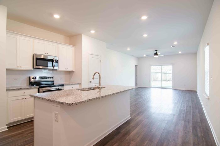 Bright kitchen with stainless steel appliances and granite countertops