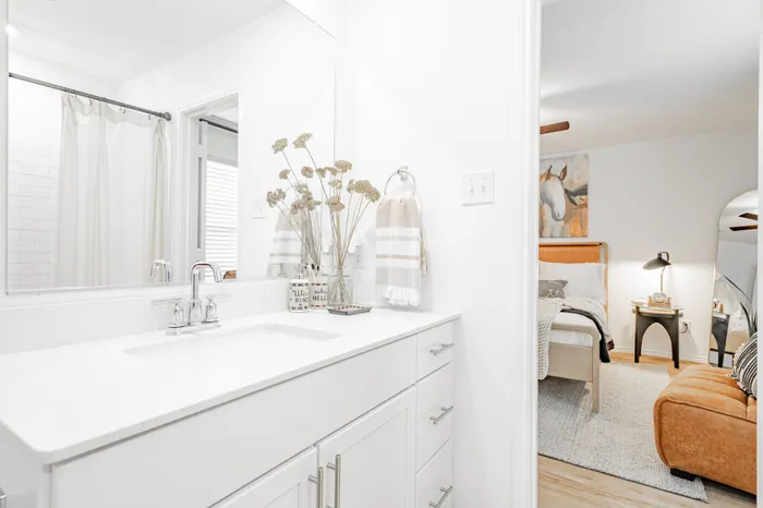 primary bathroom with white cabinets