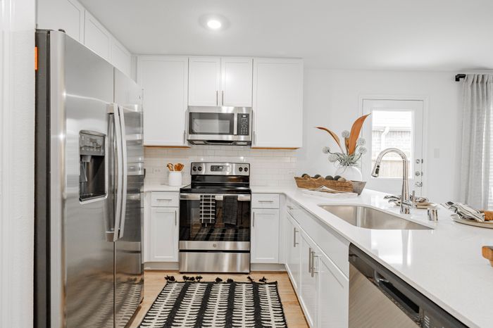 kitchen with white cabinets and counters and stainless steel appliances