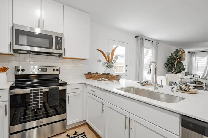 kitchen with white cabinets and counters and stainless steel appliances