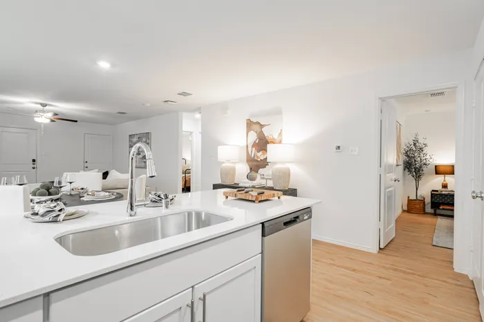 kitchen sink with stainless steel faucet looking into bedroom
