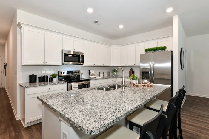 kitchen with granite island with stainless appliances