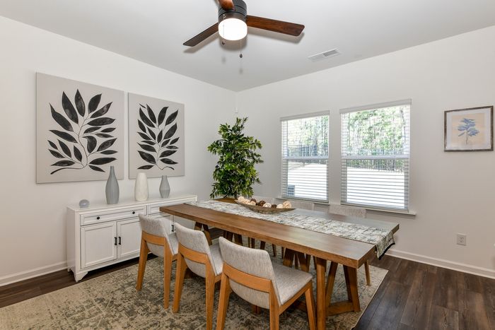 dining room with neutral colored chairs