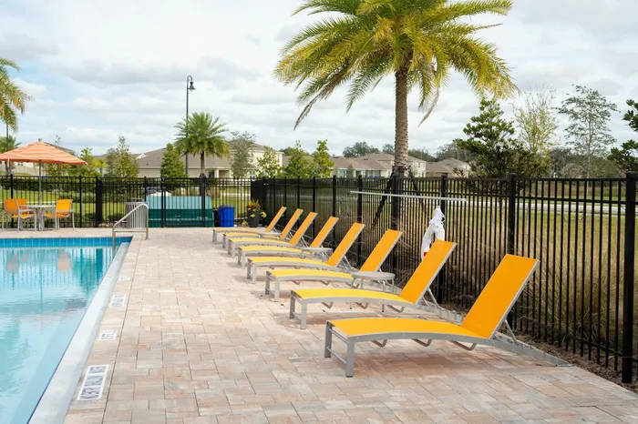 pool with orange lounge chairs