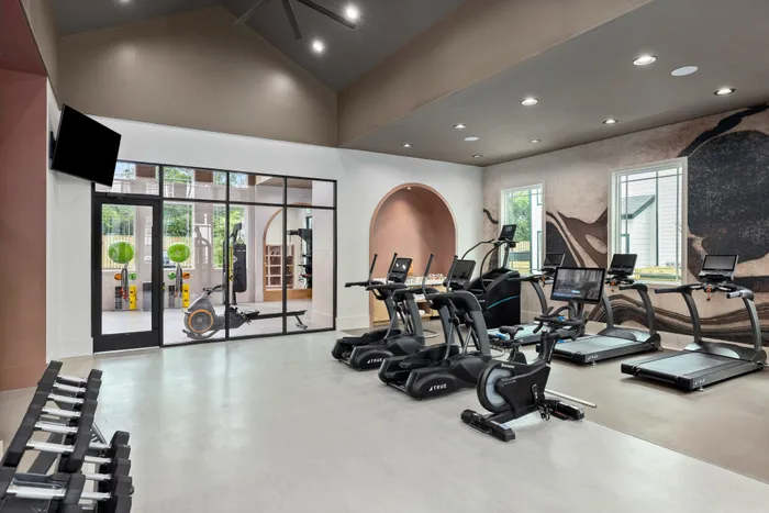Fitness center with cardio machines in apartment community