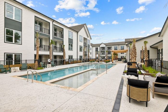 Pool deck with lounge seating at North Charleston apartment community