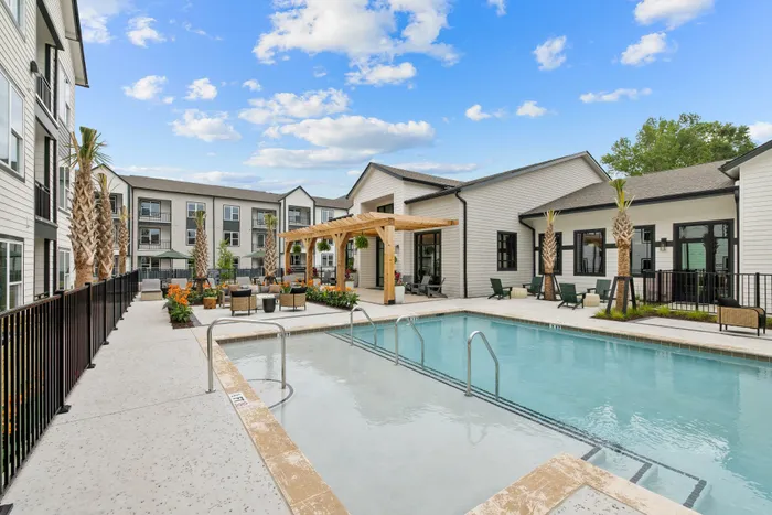 Resort-style swimming pool with surrounding lounge seating in North Charleston