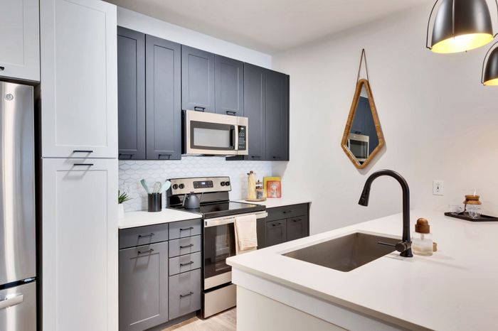 Modern apartment kitchen with spacious countertops and stainless steel appliances at Perch Apartments in South Austin.