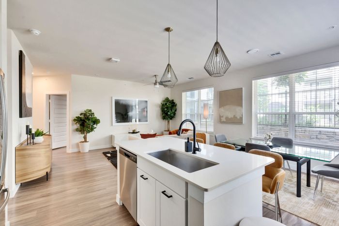 Modern apartment kitchen with two tone cabinets, countertops and stainless steel appliances at Perch Apartments.