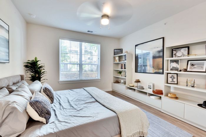 Bright apartment bedroom with large windows at Perch Apartments in South Austin.