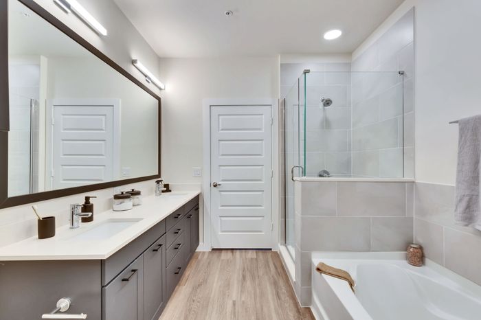 Shower and bathroom finishes inside an apartment home at Perch Apartments in South Austin, TX.