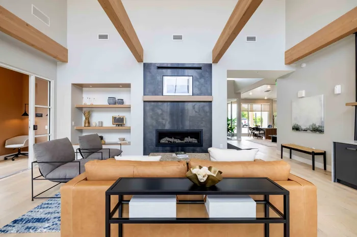 club house with brown leather couch and fireplace