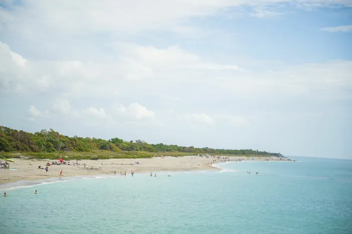 Photo of beach with blue water