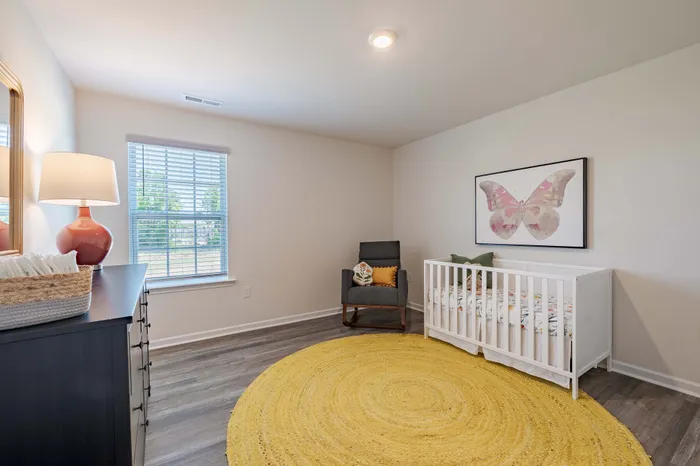 bedroom with crib and yellow rug