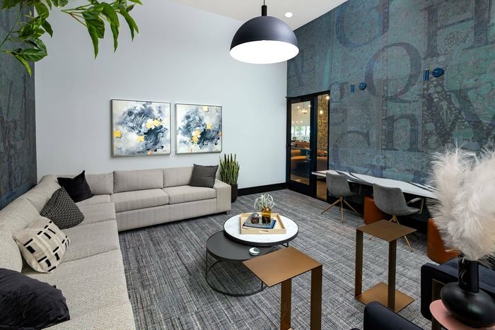 Mini lounge with sectional sofa and workspace table