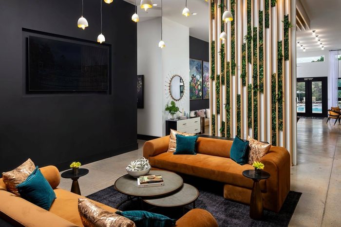 Resident Lounge Lobby Seating with modern couches and living plant wall