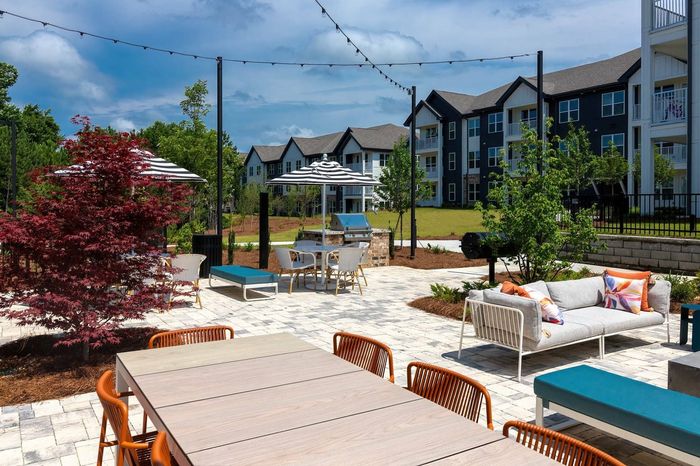Outdoor poolside lounge with tables and seating