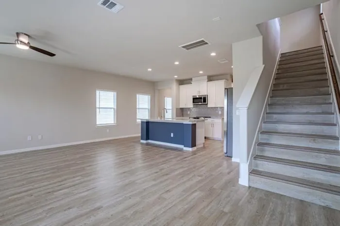 vacant living room with kitchen island