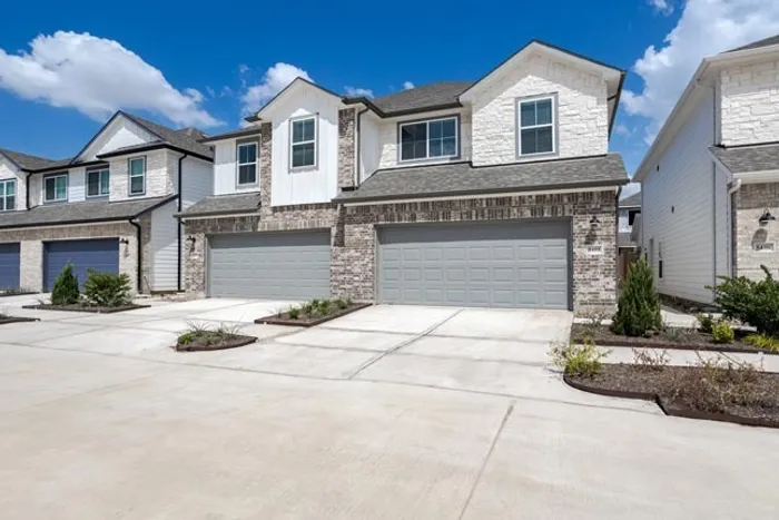 exterior townhome with garage and driveway