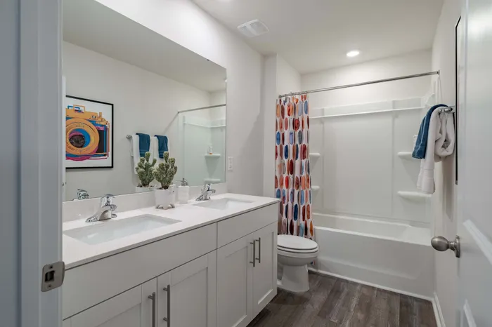 bathroom with white cabinets and dual sinks