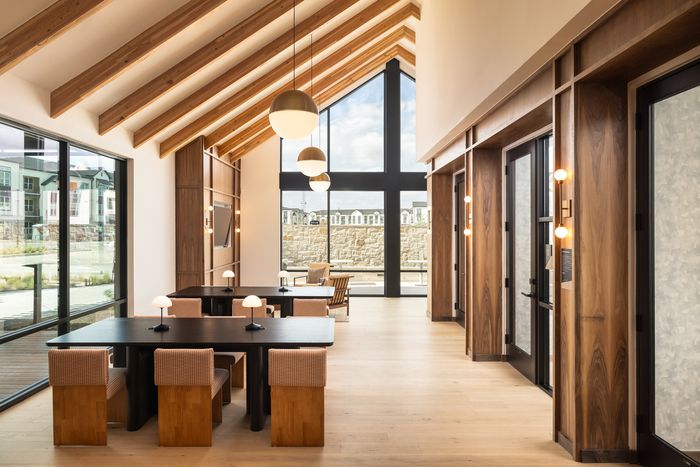 Co-working area with communal tables at The Prado apartments in Del Valle, TX