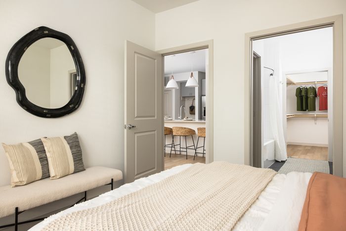 Apartment bedroom with en-suite bathroom at The Prado apartments in Del Valle, TX