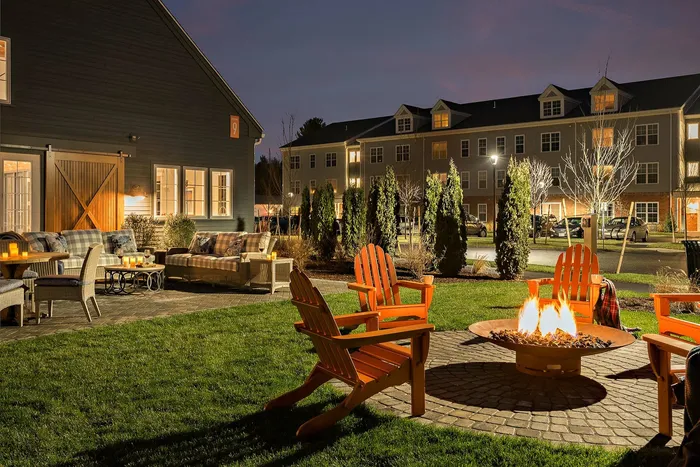 Firepit with 5 Adirondack Chairs looking at couch seating