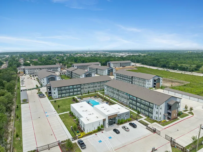 Exterior ariel view showing community clubhouse and apartment buildings