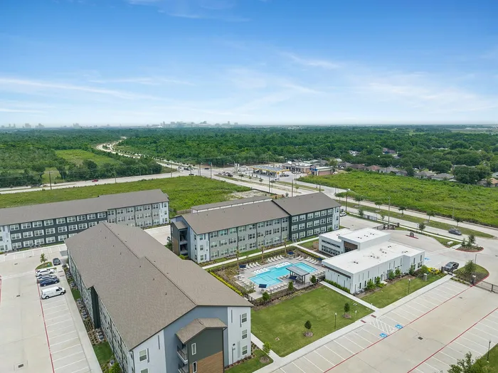 Exterior ariel view showing community clubhouse and apartment buildings