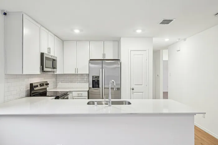 kitchen island with white cabinets and counters