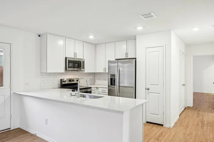 kitchen island with white cabinets and counters