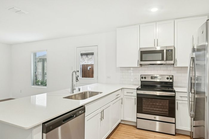 kitchen island with white cabinets and counters