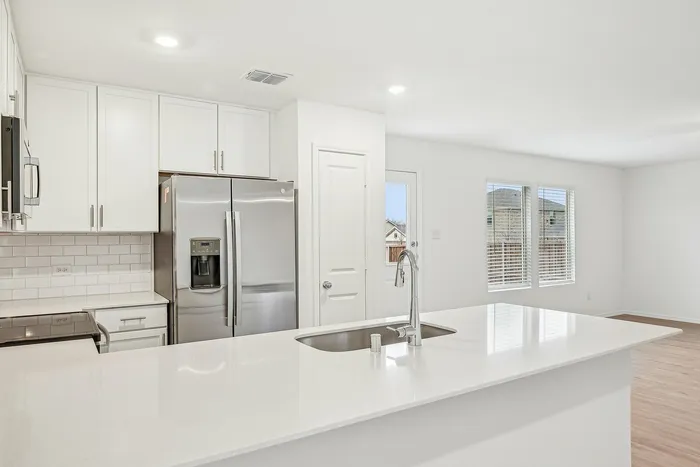 kitchen island with white cabinets and counters