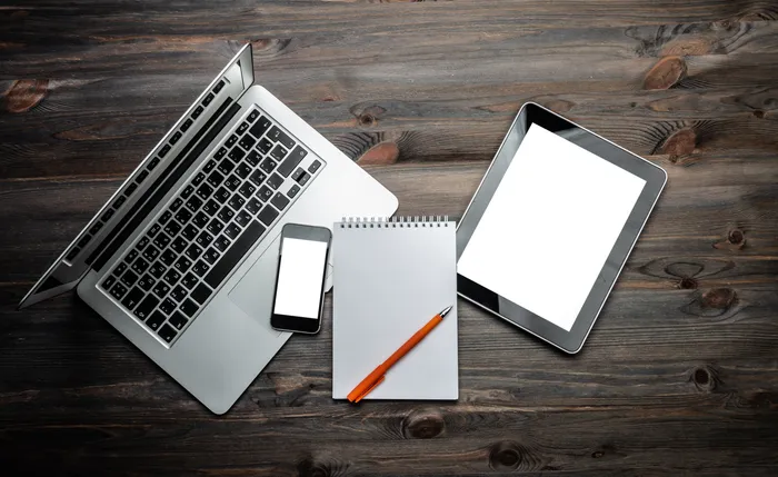 photo of laptop pad of paper and ipad