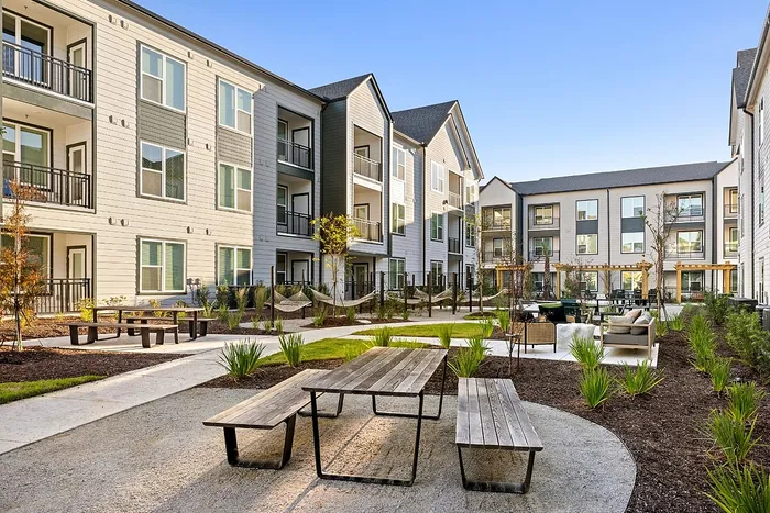 Outdoor courtyard with seating and landscaping at Asher apartments