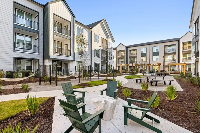Community courtyard with Adirondack chairs and green space