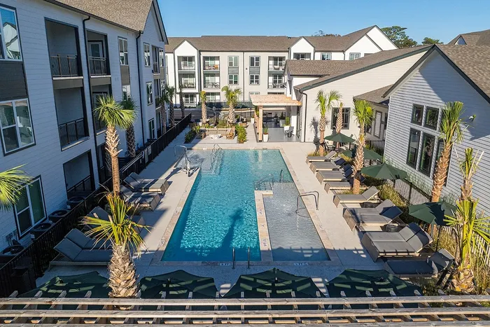 Swimming pool with lounge chairs at North Charleston apartment community