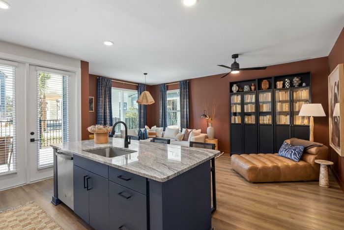 Model residence, living, dining and kitchen area in view