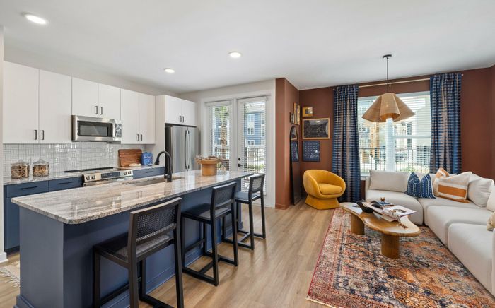 Model residence, living, dining and kitchen area in view