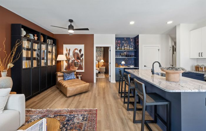 Model residence, living, dining and kitchen area in view