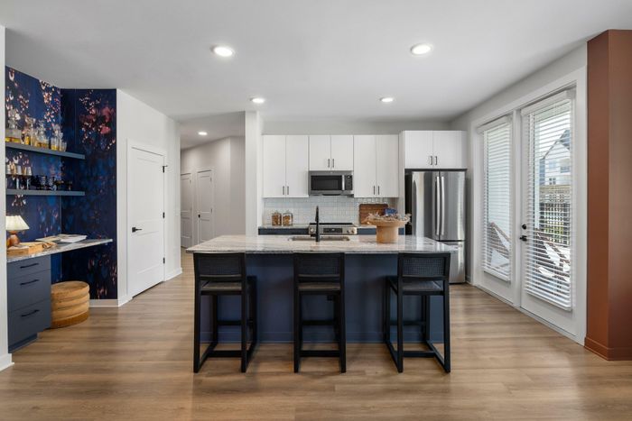 Model resident, kitchen with barstools