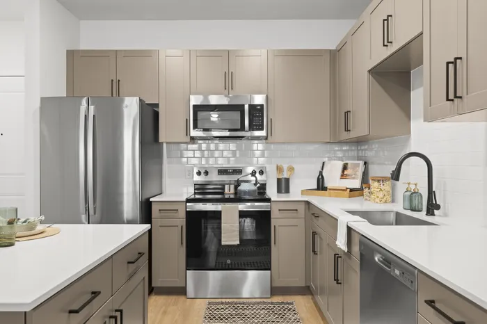 Kitchen with island and beige cabinets