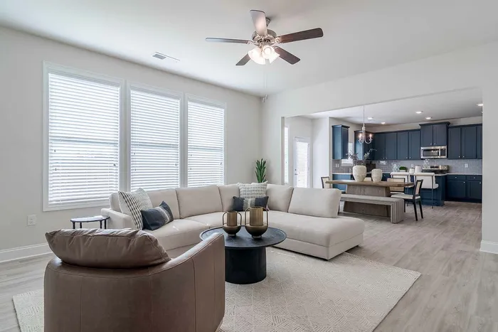 living room with tan couch and brown chair