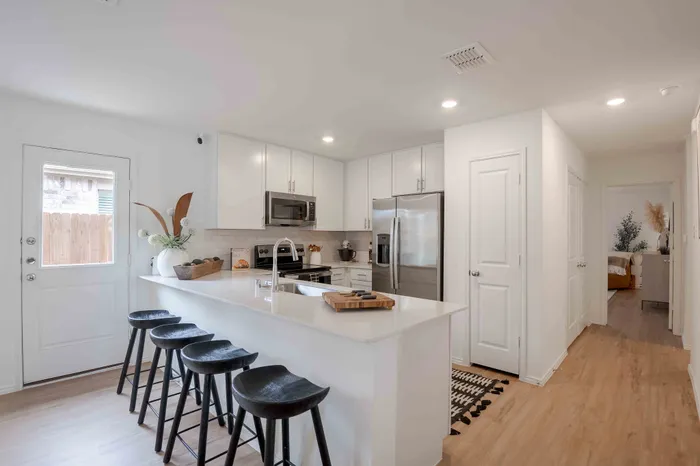 kitchen island with white counters and white cabinets