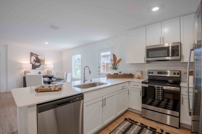 kitchen island with white counters and white cabinets